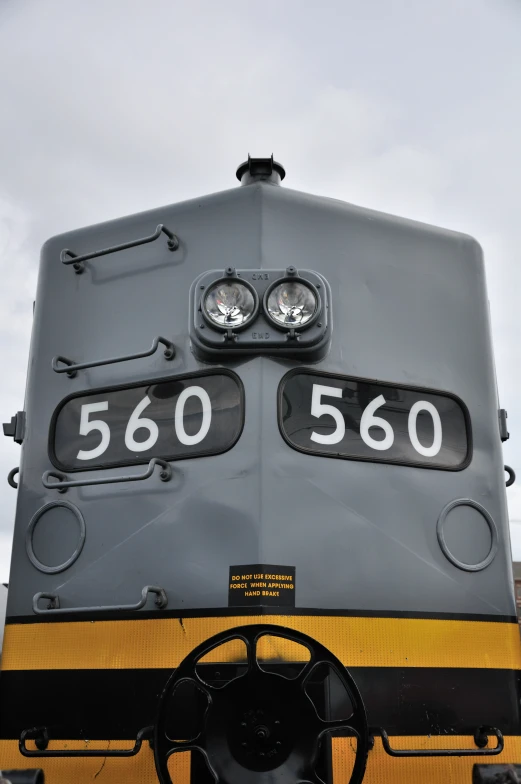 the front of a train car with wheels and number plates on it