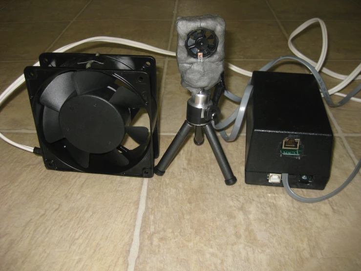 a light source is next to an analog camera and fan