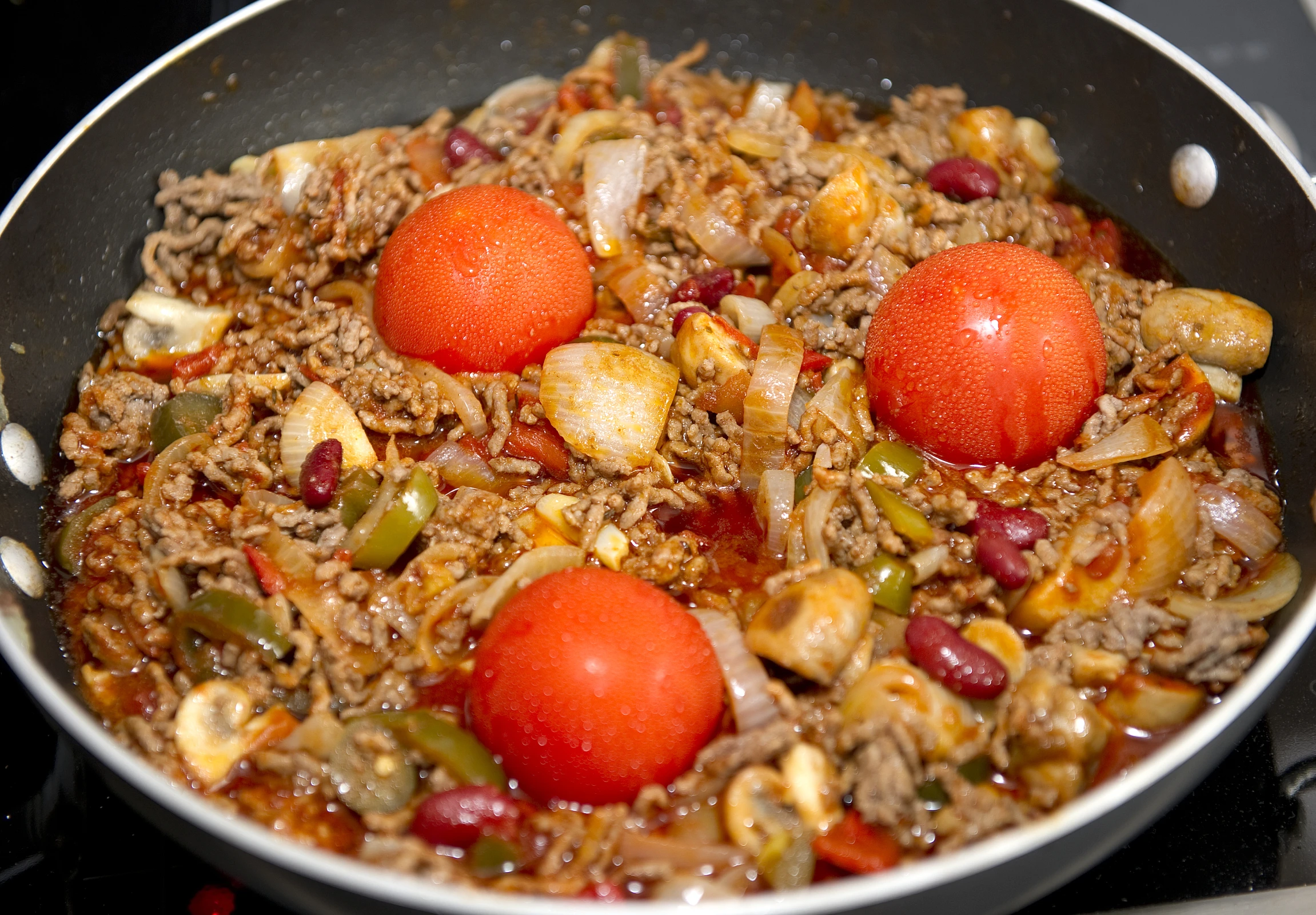 a pan with food being cooked and prepared to be eaten