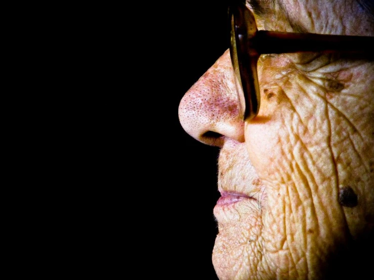 an older man wearing glasses with eyeliners on