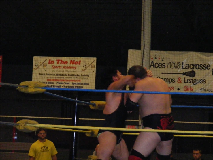 the two wrestling players are in an indoor arena