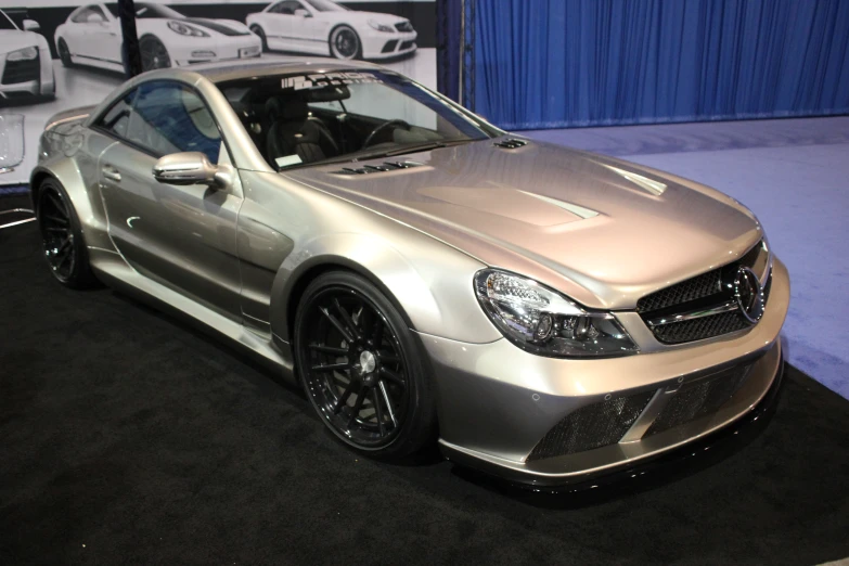 a mercedes c - class in silver on display at a car show