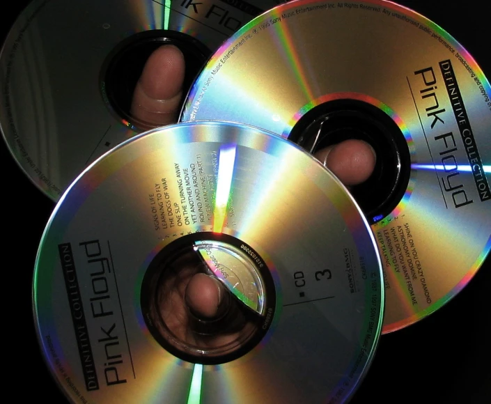 three different dvd discs with green, white and blue logos