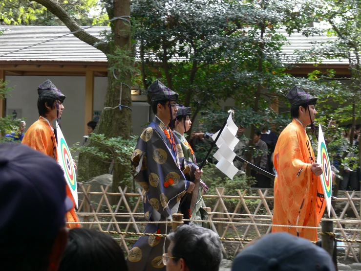people dressed in traditional japanese clothing holding a flag