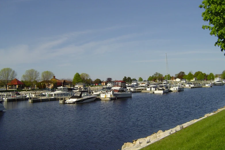 a bunch of boats on the water on a sunny day