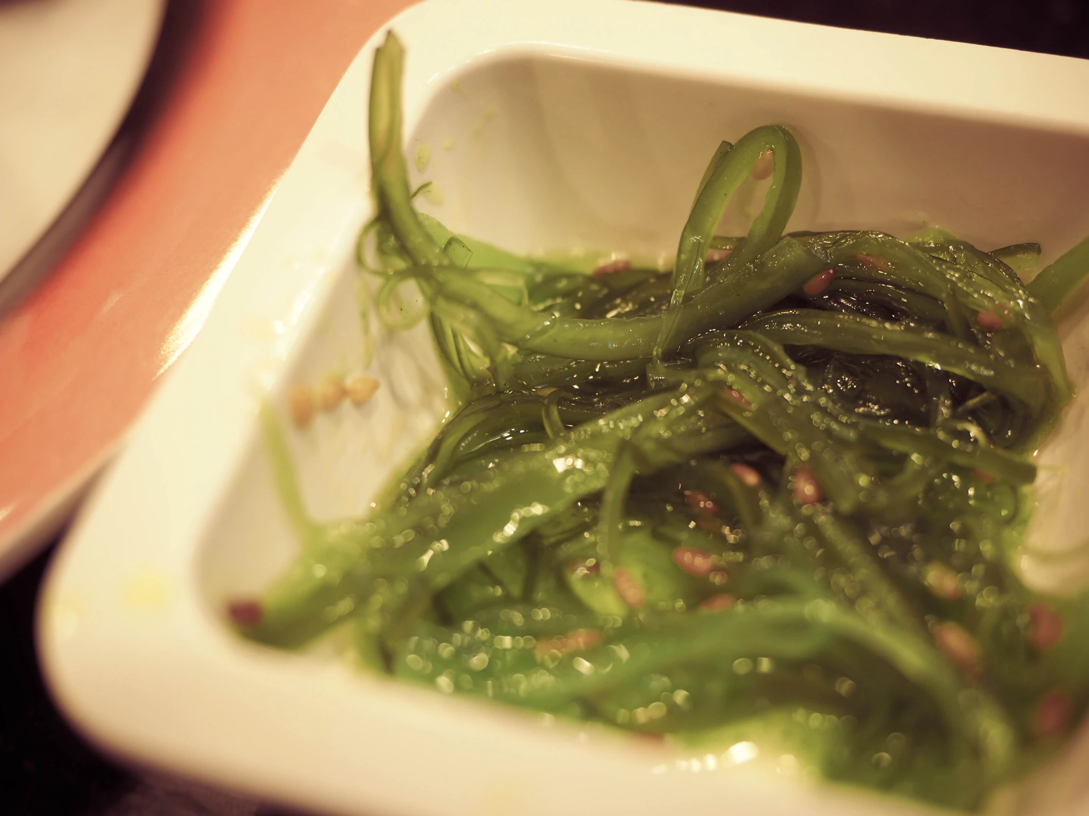 a dish with green seaweed in it