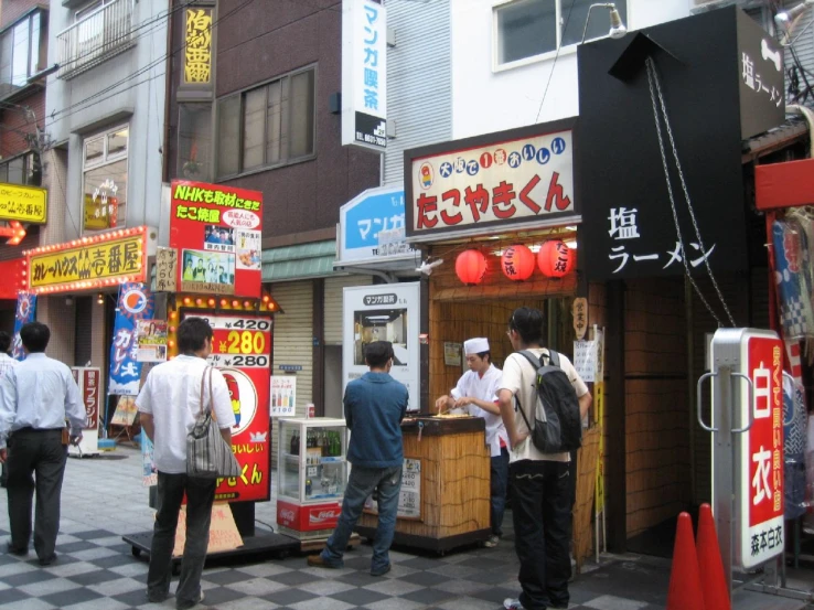 the man in the suit is getting food from the kiosk