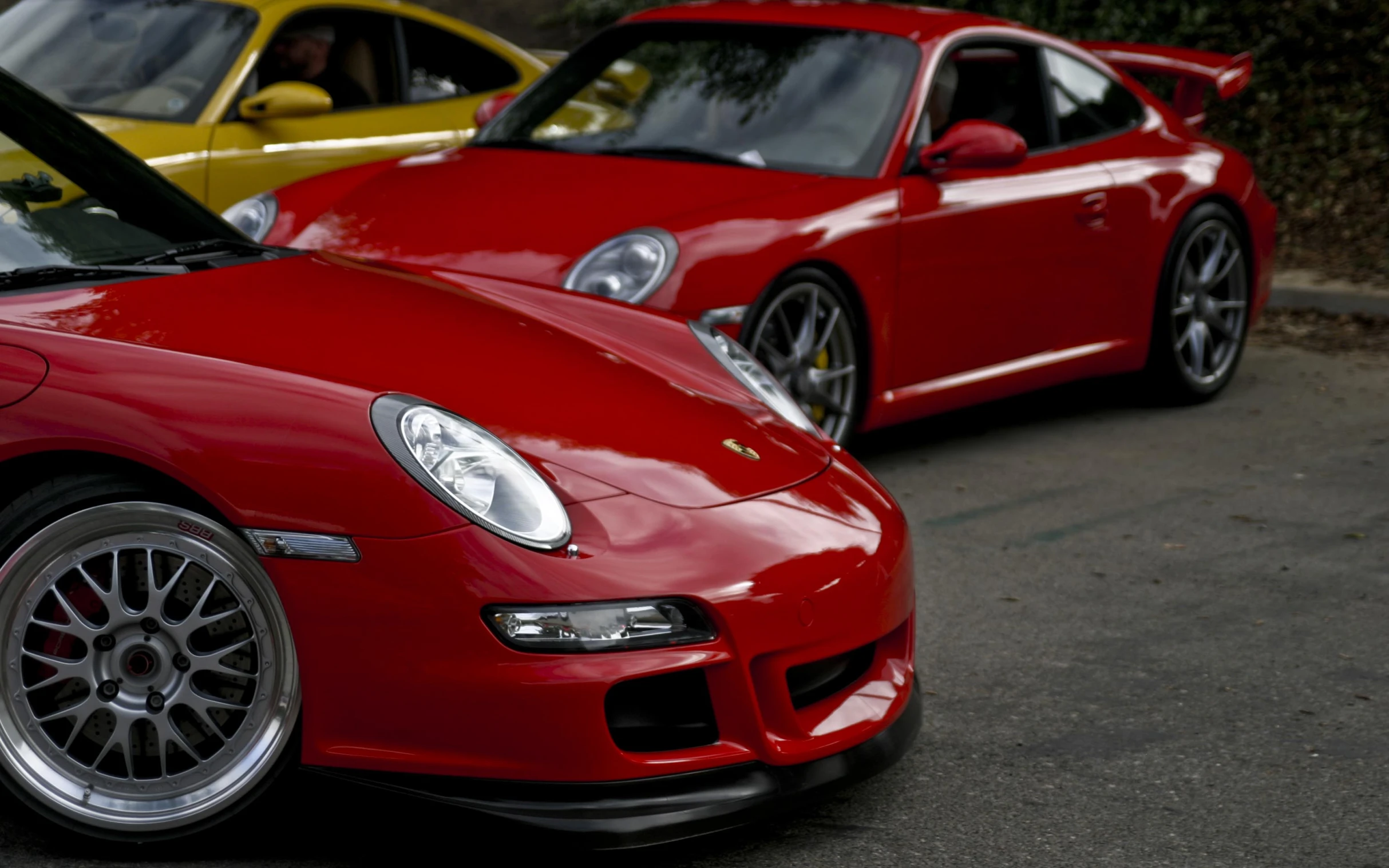 two red sports cars parked next to each other