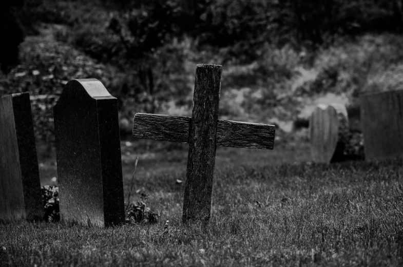 some old graves are sitting in the grass