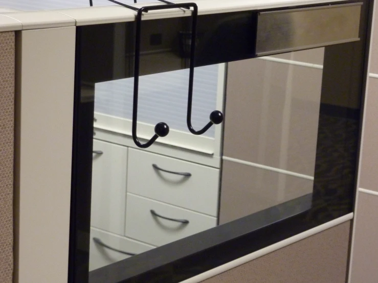 a pair of handles are attached to the front of a cubicle window
