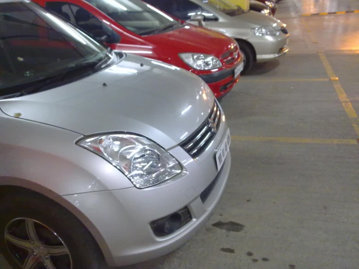 four cars parked next to each other in a parking garage