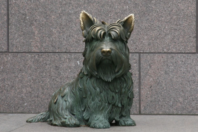 a green statue dog sits in front of a wall