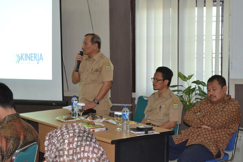 two police officers giving a lecture to some people