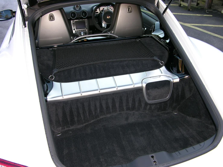 the trunk is open on an automobile with the door open