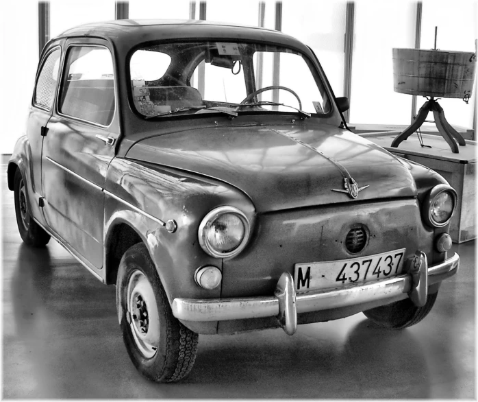 an old po of a man looking in his classic car