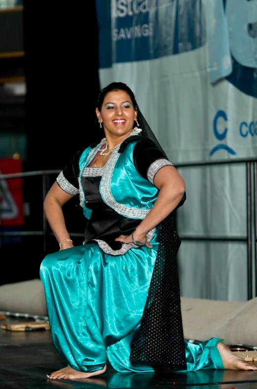 a belly dancer is smiling while posing for a picture