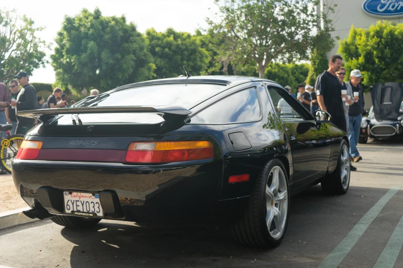 a black sports car parked on the side of the street