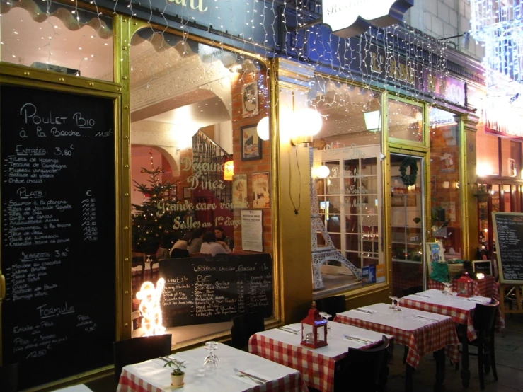 a restaurant decorated for christmas with large windows