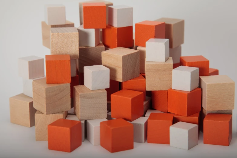 a pile of colorful cubes on a white background