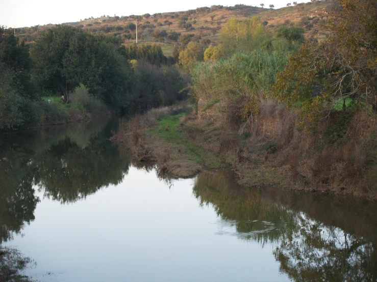 a river in the middle of a hilly area