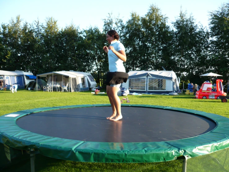 a man on top of a small trampoline in a park