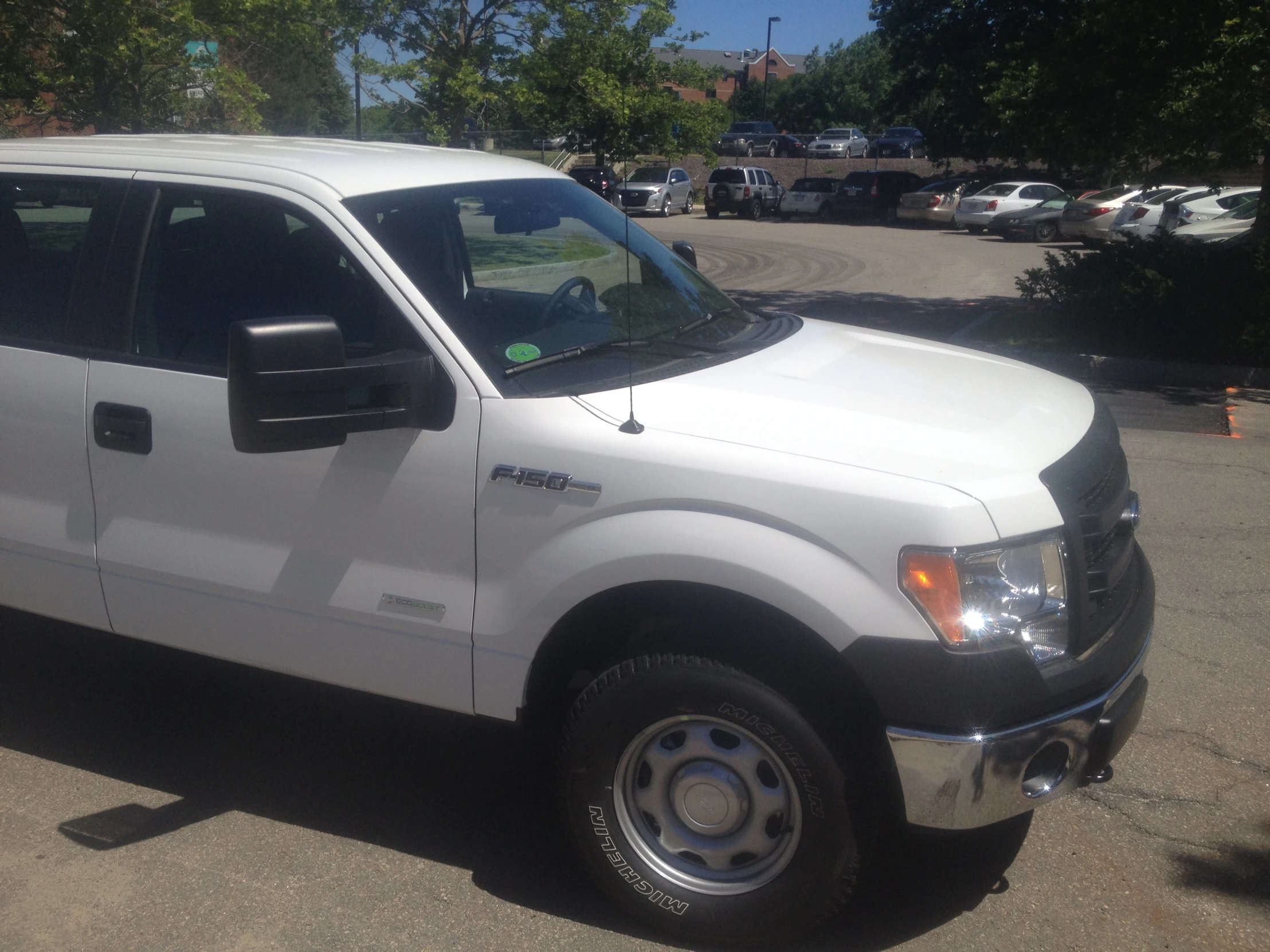 a white pickup truck parked in a lot