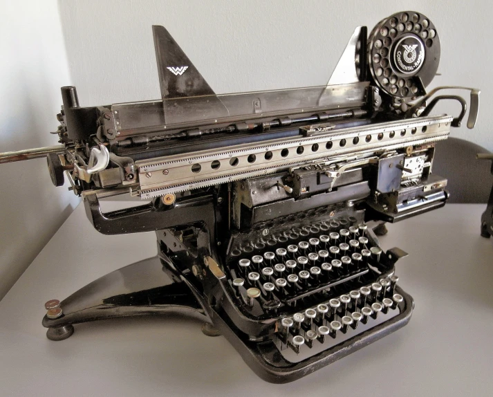an antique typewriter sitting on a table with a bunch of keys on it