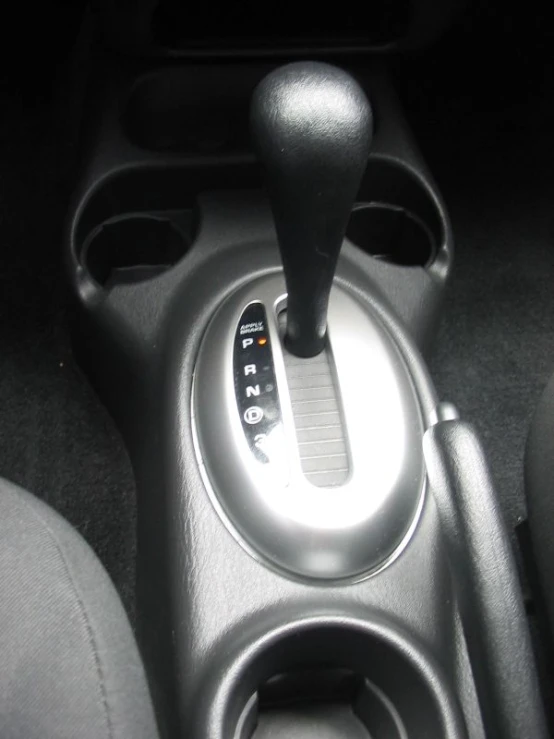 car interior showing gear selector, steering wheel and center console