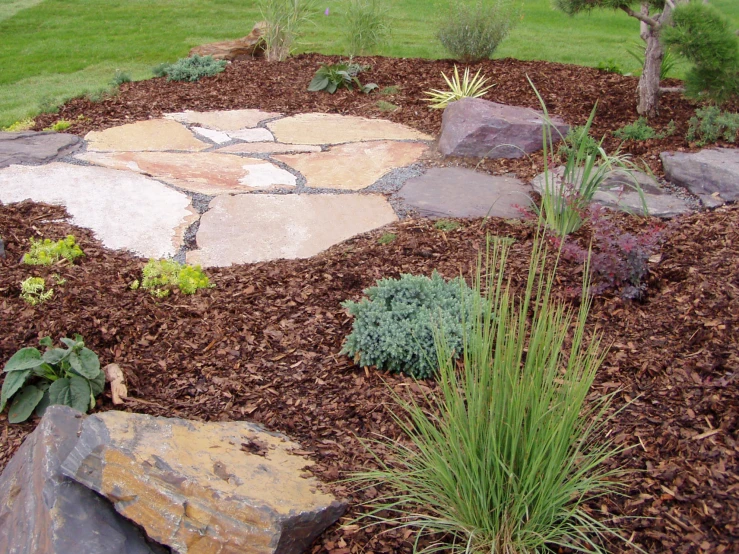 this garden has several flags and stone in it