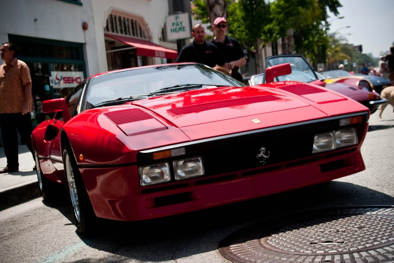 red sports car parked on the side of the street