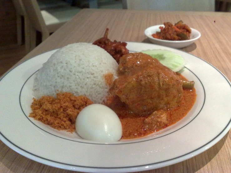 an asian meal, including meat, rice and egg