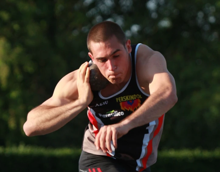 a young man in motion, about to throw a frisbee