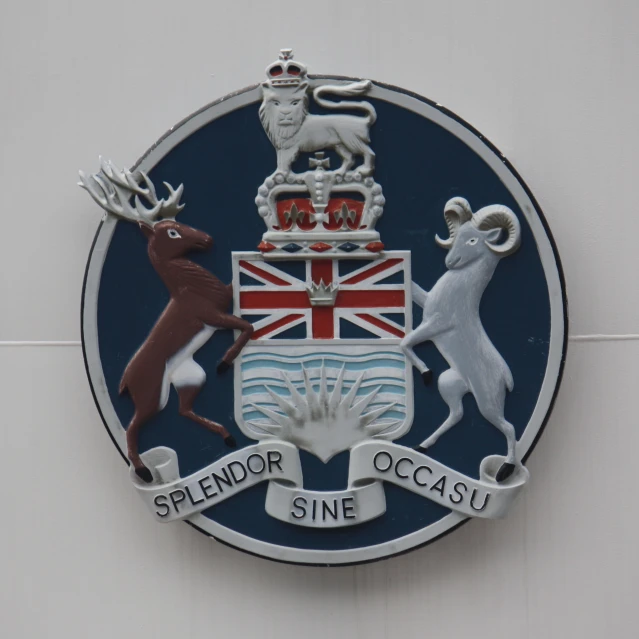 the emblem on a building is depicting sheep, lion, deer and moose