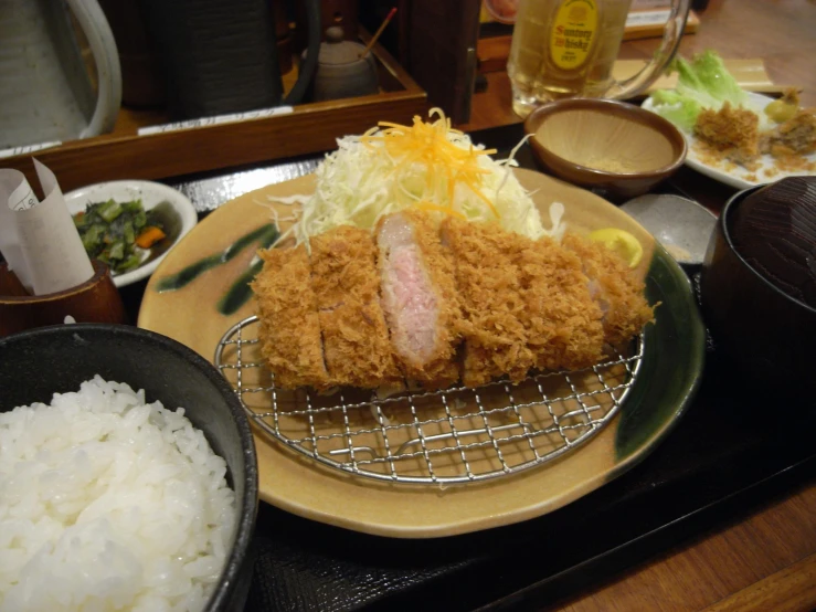 a meal made of meat and rice is being displayed on a plate