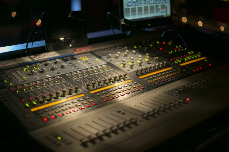 a professional sound board in front of a monitor