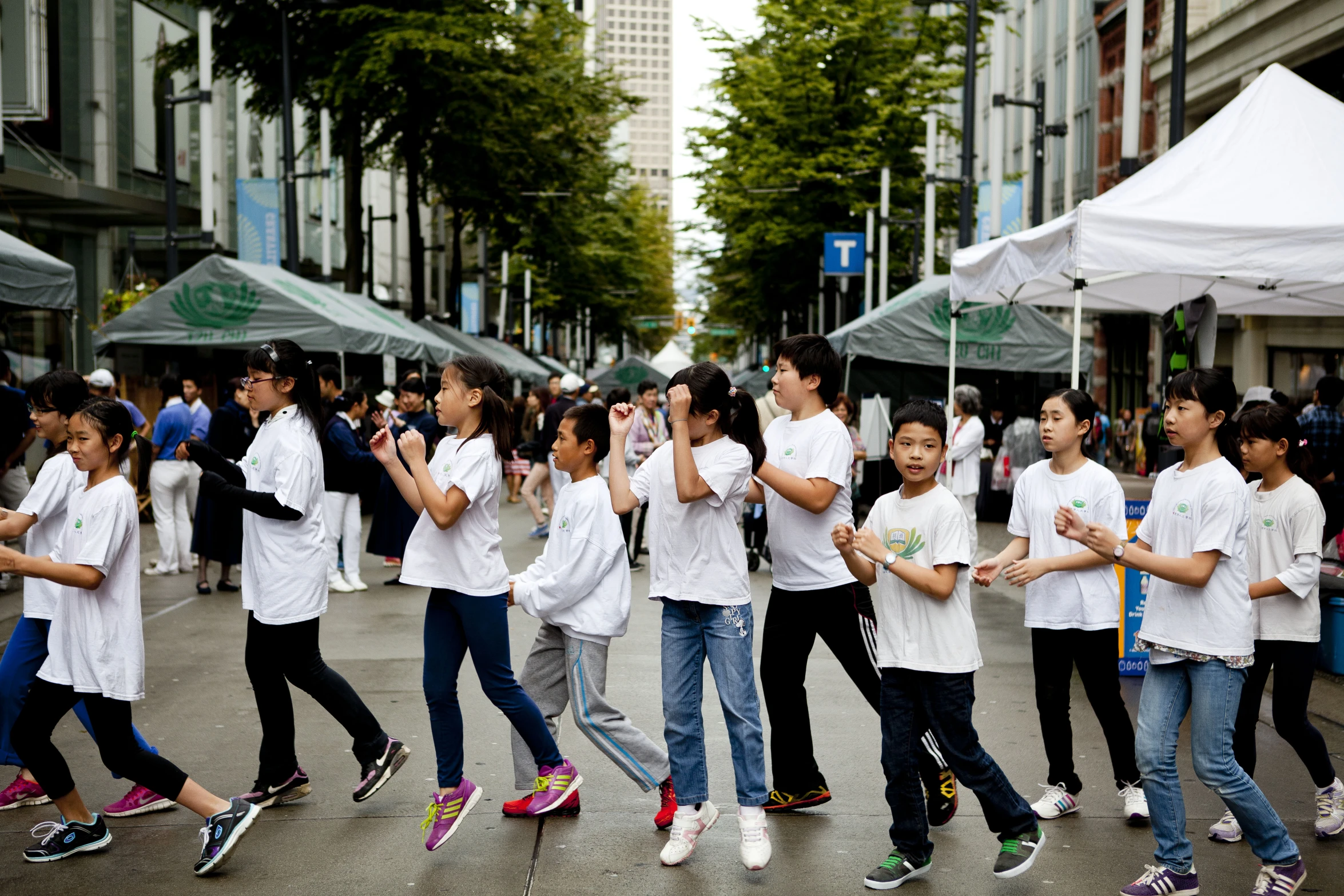 children are dancing around in a line