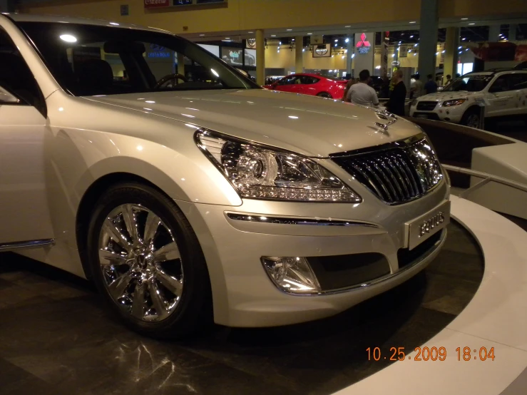 the white car is on display at the show