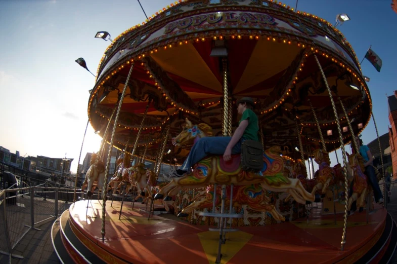 a  rides a colorful merry go round