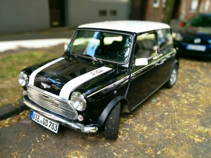 an image of a miniature car that is sitting on the pavement