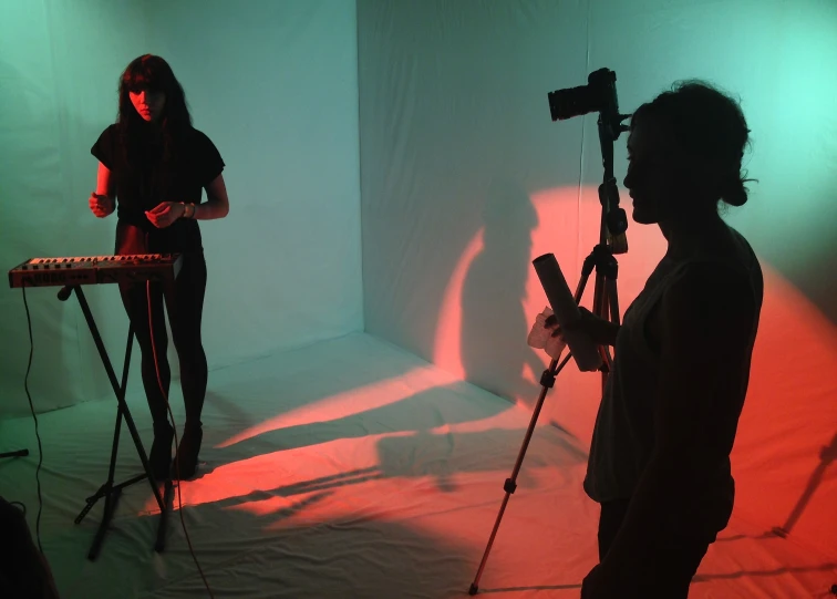 a person standing in front of a piano, keyboard and lights