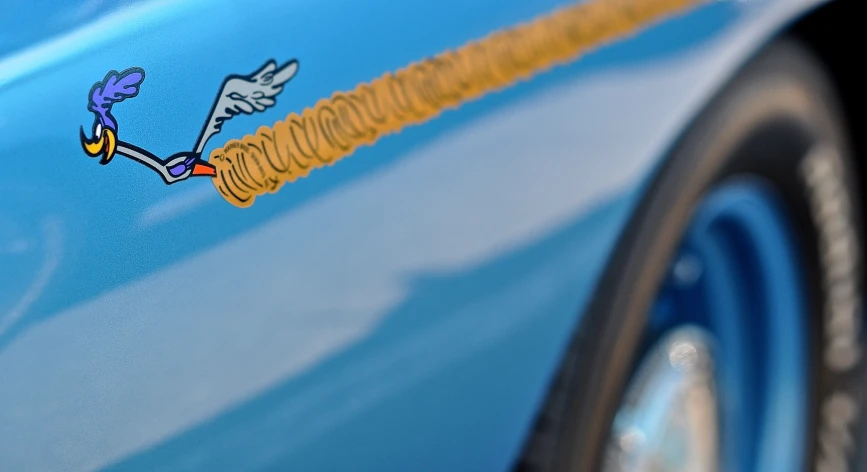 a close up of a blue car's side door with stickers