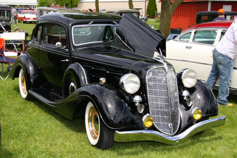 vintage car at a car show with open hood