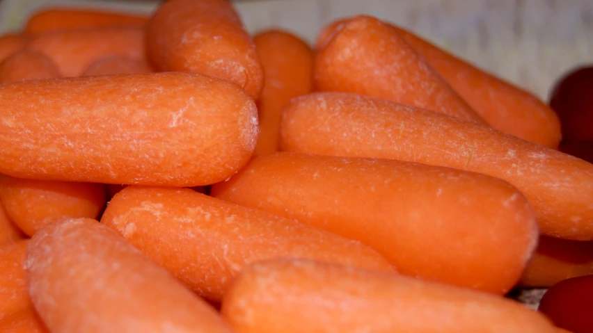 the fresh, uncooked carrots have been piled high