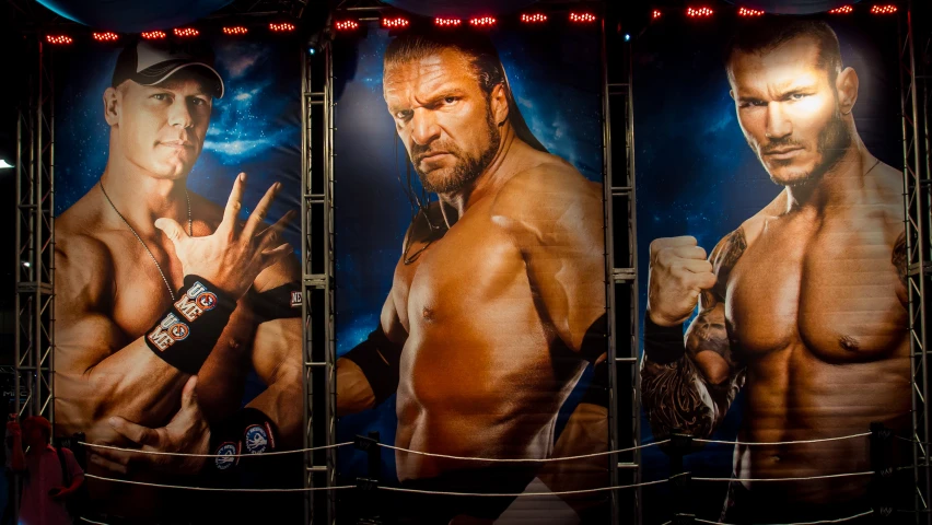 a large poster of the wrestler john cenafocci next to him