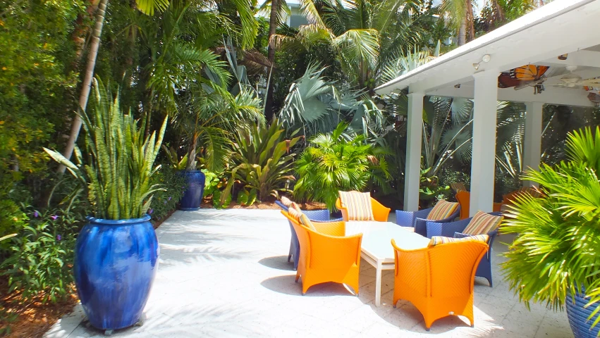 an outdoor lounge area has blue and orange chairs