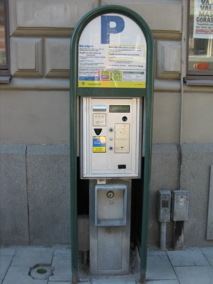a pay phone sitting in front of a building