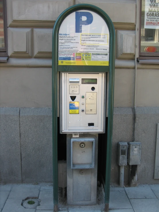 a pay phone sitting in front of a building