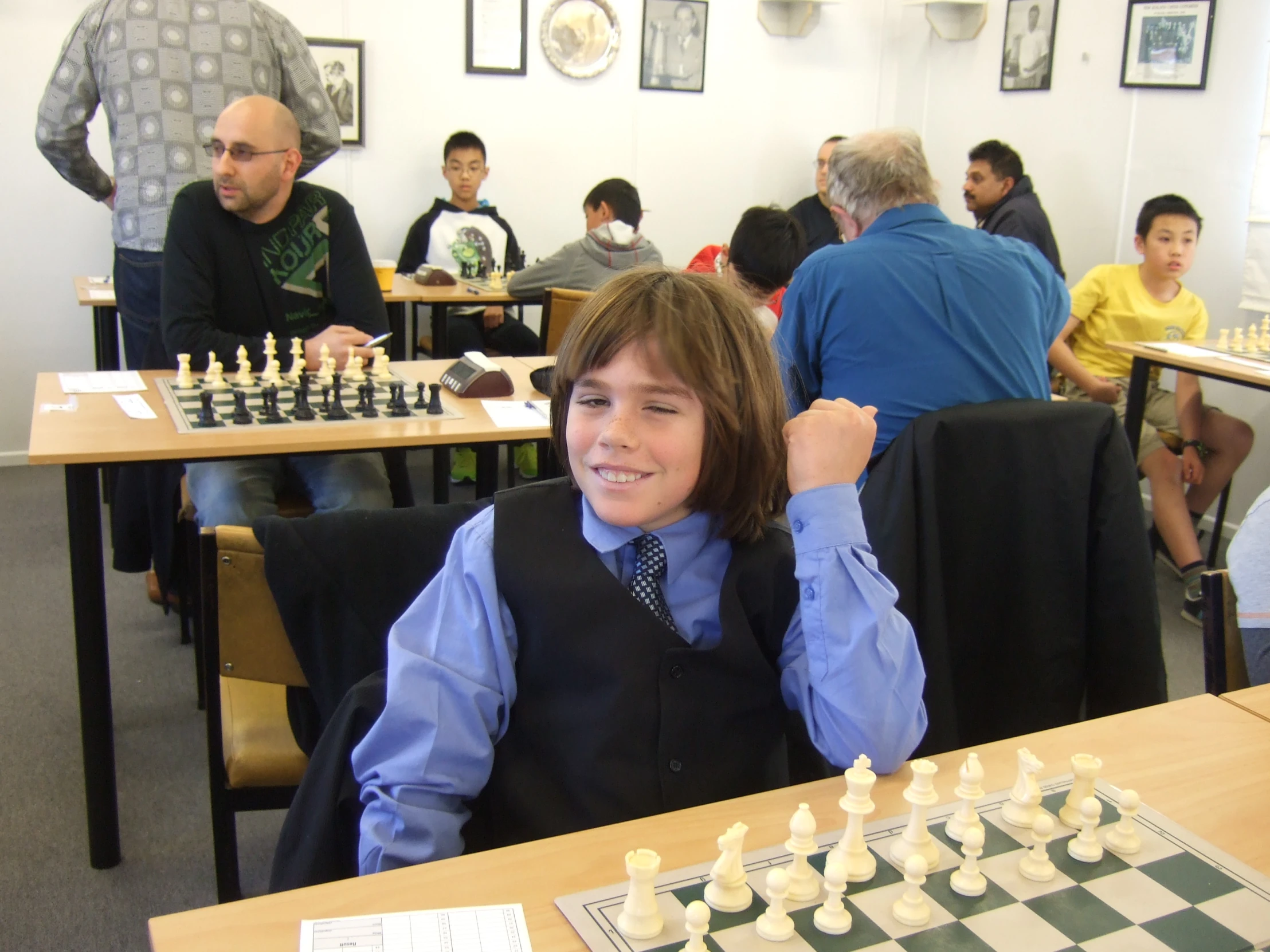 a little boy that is sitting at a desk