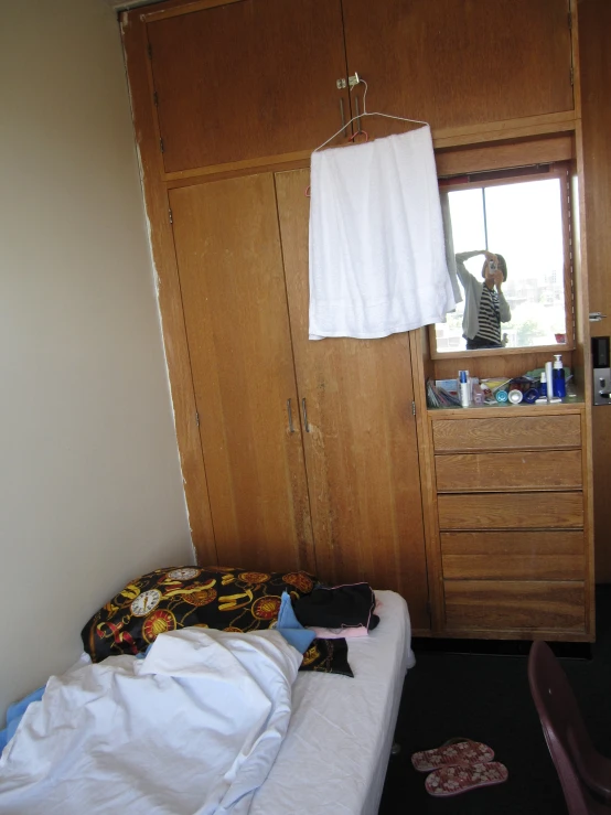 the bedroom with clothes hanging from the clothes rails