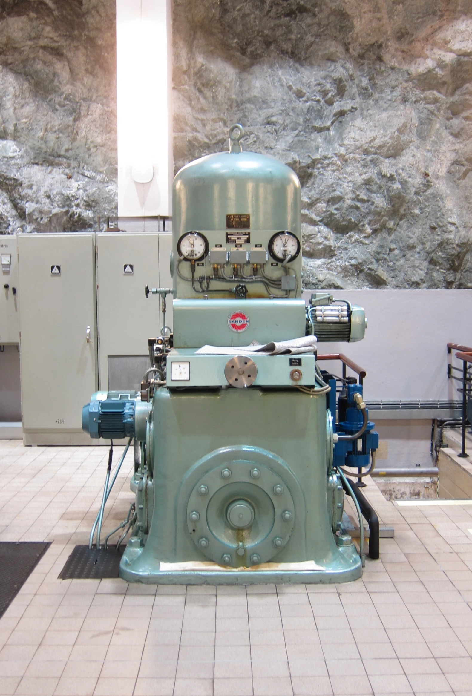 an industrial mechanical machine on display inside a building
